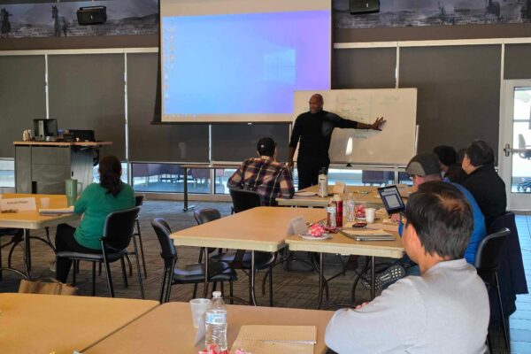 Al Nolan, Principal Advisor at Overlap Capital, talking through some small business financial products with Balfour Beatty learning center cohort at Dallas Community college.